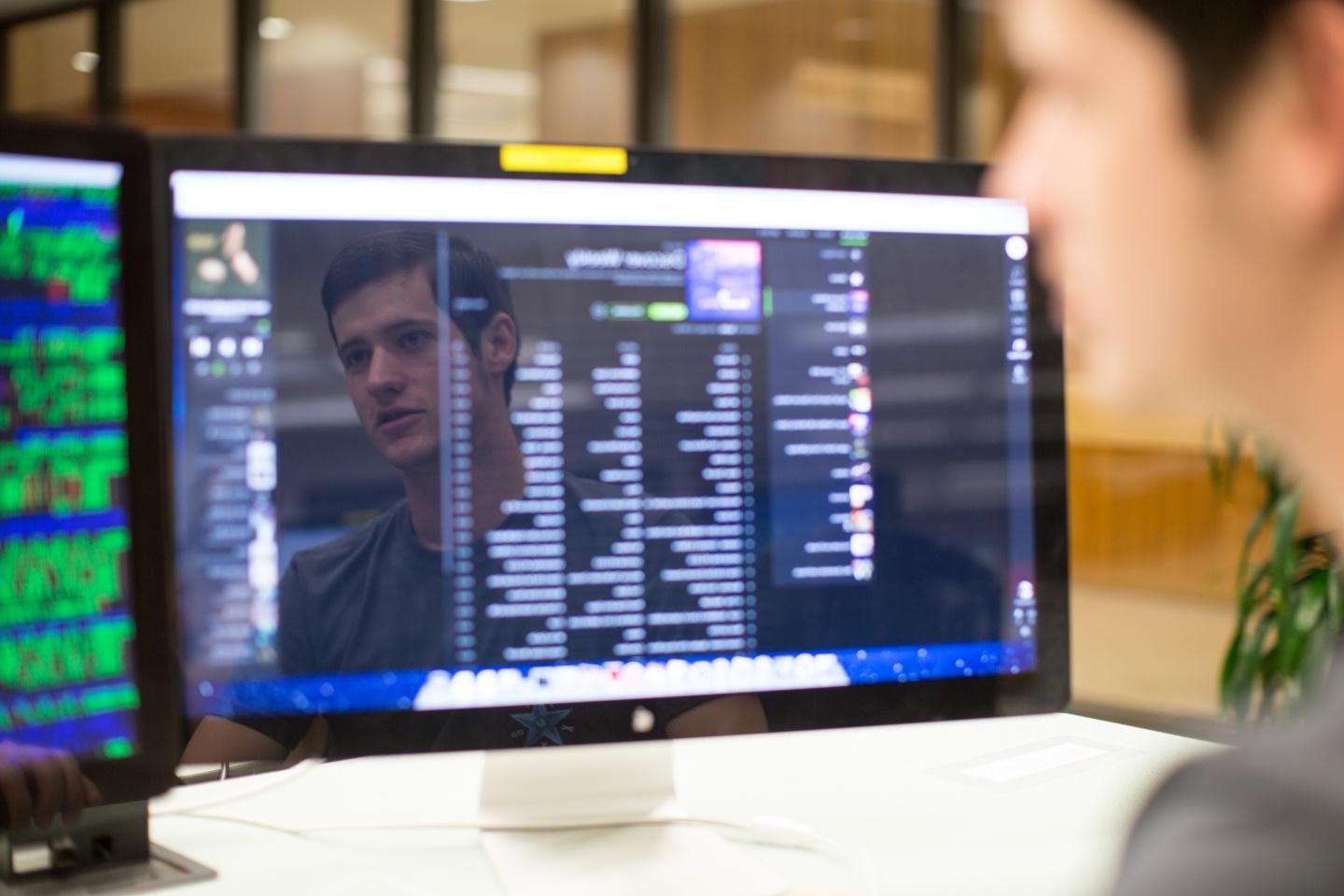 Student looking at computer code. 